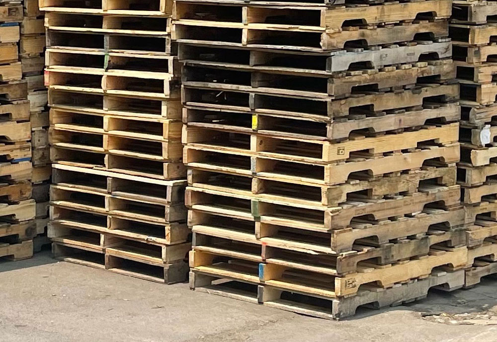 stack of used and recycled wooden pallets